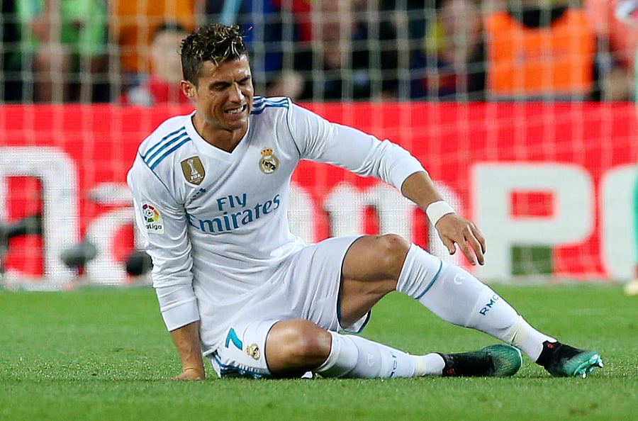 WINCING IN PAIN Real Madrid will hope Cristiano Ronaldo can recover from a knock he received against Barcelona on Sunday. REUTERS