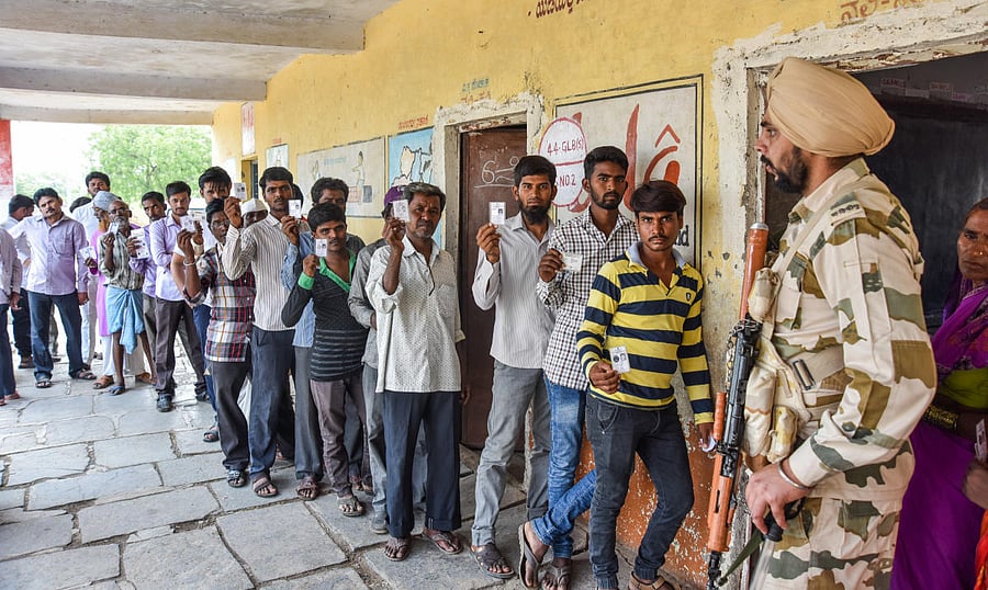 Men stand queue to exercise their franchise for Assembly Election Kalaburagi South at Bhimalli Polling Station in Kalaburagi Taluk on Saturday. DH Photo for representation only.
