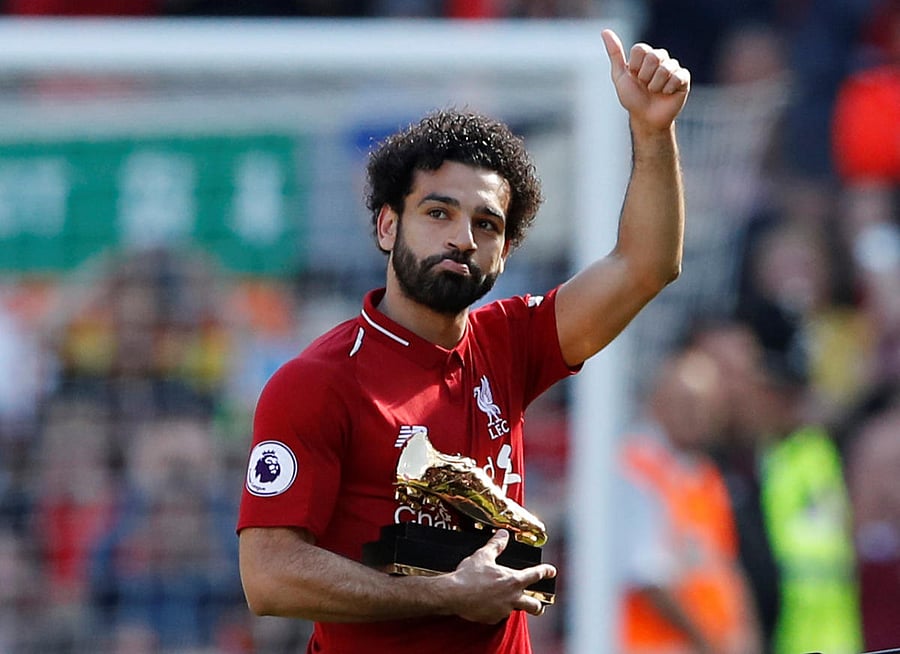 Record breaker: Liverpool's Mohamed Salah celebrates with golden boot after beating Brighton & Hove Albion on Sunday. Reuters