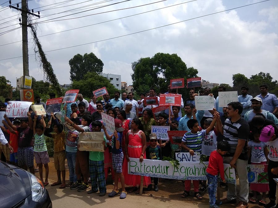 Residents form a human chain seeking the authorities to protect the Pattandur Agrahara Lake, on Sunday.