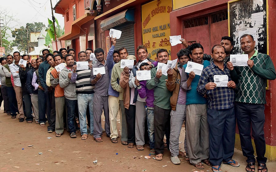 Voters wait in a long queue to cast their votes for Assembly elections, at a polling station in Dimapur, Nagaland on Tuesday. PTI 