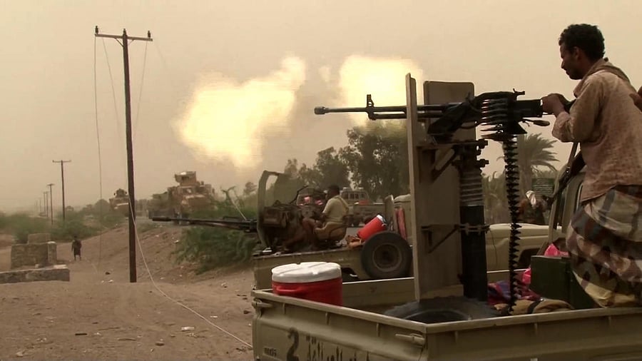 This image grab taken from a AFPTV video shows Yemeni pro-government forces firing a heavy machine gun at the south of Hodeida airport, in Yemen's Hodeida province on June 15, 2018. AFP