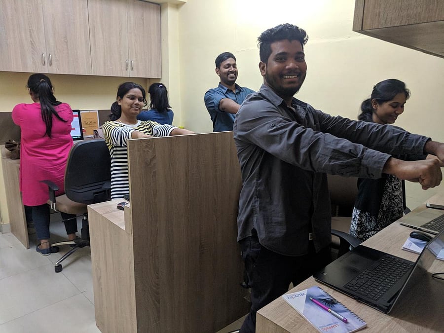 The staff of Markelytics Solution Ltd practise desktop yoga .