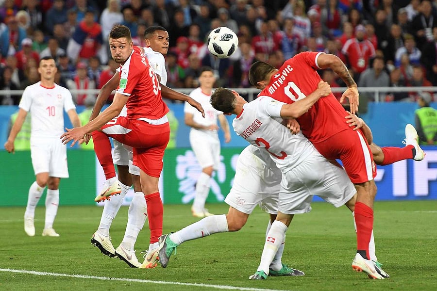 Serbia's forward Aleksandar Mitrovic (right) is held by Switzerland's Stephan Lichtsteiner and Fabian Schar in the penalty area. AFP