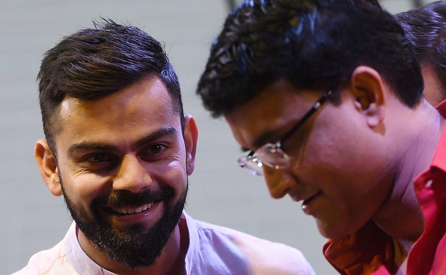 Former India skipper Sourav Ganguly (right) says he is happy Virat Kohli didn't play in county cricket ahead of the five-Test series. AFP