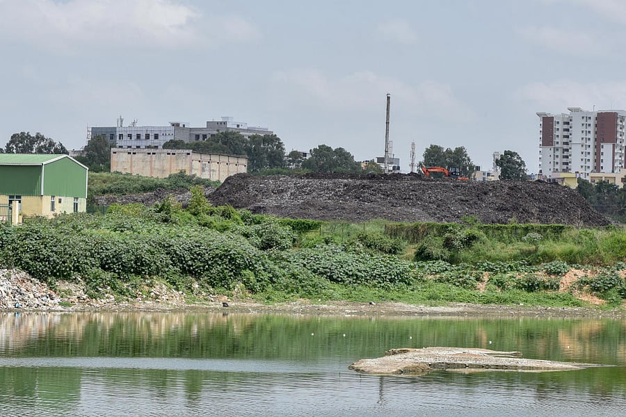 Refuse-derived Fuel (RDF) accumulated on the Somasundara Palya lakebed has been emitting fumes for the past two weeks. DH PHOTO/S K DINESH