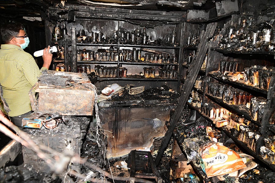 An official inspects the damage caused by the deadly fire in Kailash Bar and Restaurant, Kalasipalyam, on January 8, 2018. DH FILE PHOTO