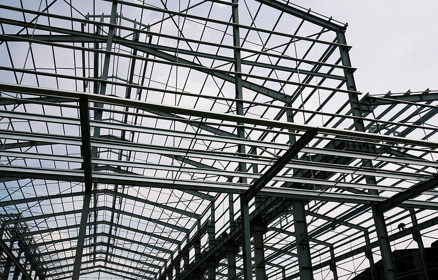 A man paints steel structures of a new factory in Hanoi, Vietnam May 30, 2018. Picture taken May 30, 2018. REUTERS
