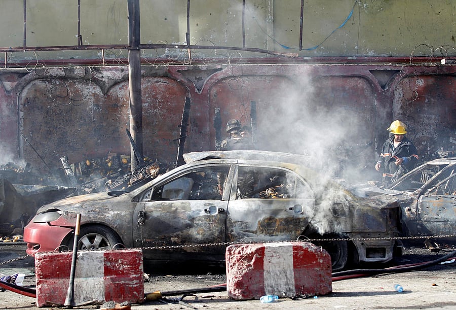 Afghan officials inspect the site of a blast in Jalalabad city, Afghanistan, July 1, 2018. REUTERS