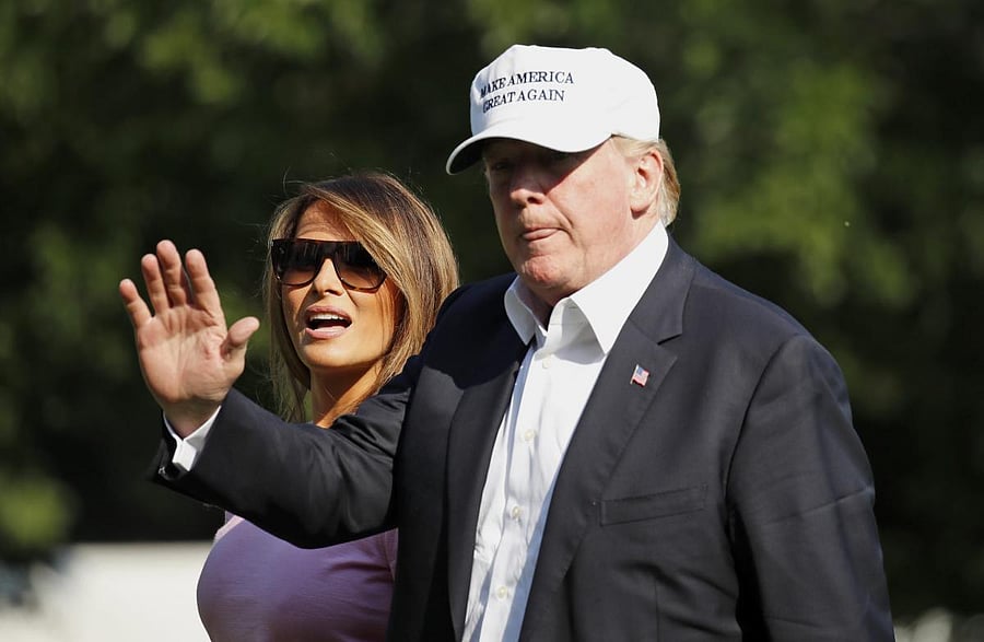 President Donald Trump waves after stepping off Marine One, accompanied by first lady Melania Trump, on the South Lawn of the White House. (AP/PTI Photo)