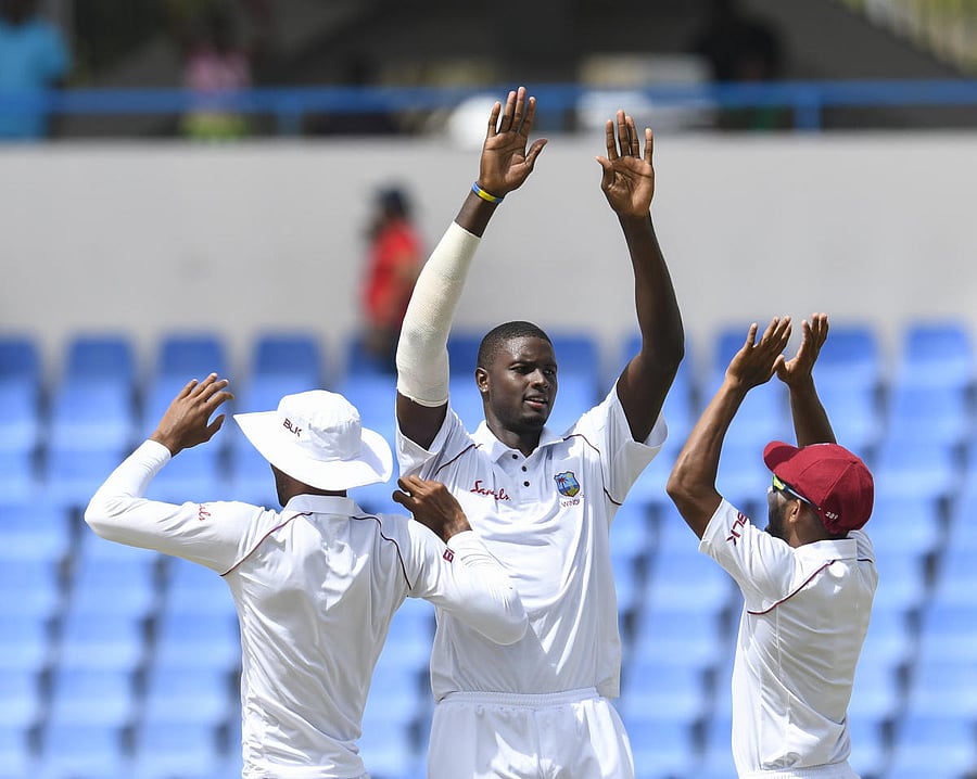 HAPPY BUNCH: Jason Holder (centre) of West Indies celebrates the dismissal of Mahmudullah of Bangladesh. AFP