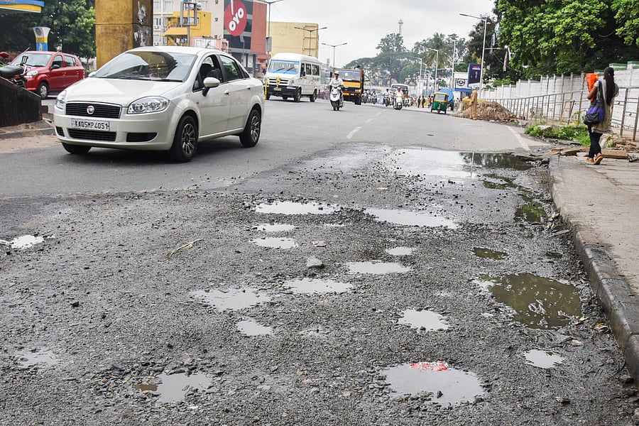 A potholes-filled stretch at Sirsi Circle, Mysuru Road. DH photo/S K Dinesh