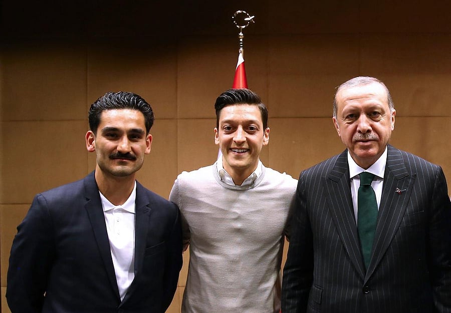 Germany's Mesut Ozil (centre) has no regret about his photograph with Turkish president Recep Tayyip Erdogan (right) that sparked a controversy. Also seen is Iikay Gundogan. AFP   