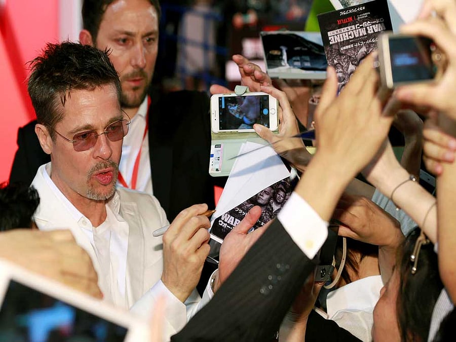Ryan Reynolds has revealed that Hollywood star Brad Pitt wanted the actor to bring a cup of coffee for him as his fee for doing a cameo in "Deadpool 2". PTI file photo