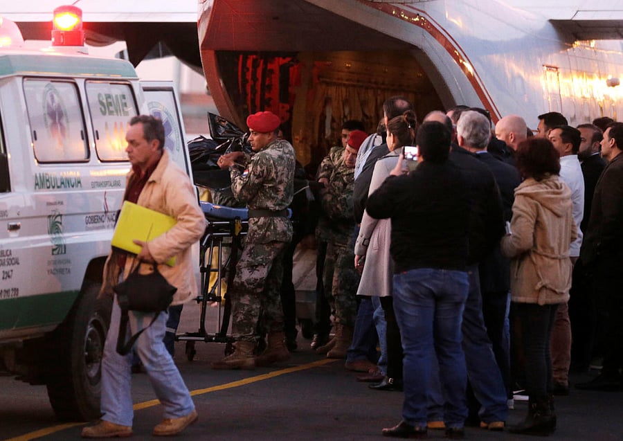 Soldiers unload bodybags with the remains of the passengers, including Paraguay's Agriculture Minister Luis Gneiting, of a twin engine airplane that crashed on Wednesday night, in Luque, Paraguay on Thursday. (REUTERS/Jorge Adorno)