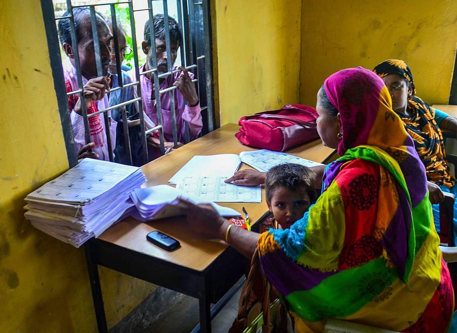 People wait to check their names on the final draft of the National Register of Citizens (NRC) after it was released, at NRC Seva Kendra, Goroimari in Kamrup district of Assam on Monday, July 30, 2018. (PTI Photo)