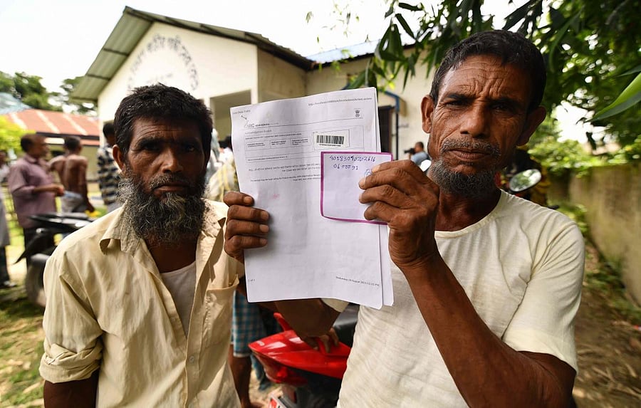 A resident holds documents on his way to check names on the final list of National Register of Citizens (NRC) in Kuranibori village in Morigoan district of Assam on Monday. AFP