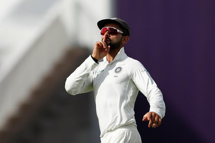Virat Kohli celebrates after running out England's Joe Root. Reuters