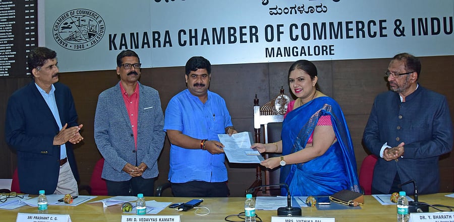 Kanara Chamber of Commerce and Industry President Vathika Pai submits a memorandum to Mangaluru City South MLA D Vedavyas Kamath at an interactive meeting in Mangaluru on Friday. KCCI Vice-President P B Abdul Hamid looks on.