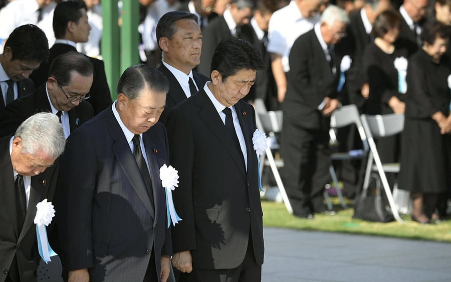 Japan's Prime Minister Shinzo Abe and other officials offer a silent prayers for the victims of the 1945 atomic bombing, at Peace Memorial Park in Hiroshima, western Japan, August 6, 2018, on the 73rd anniversary of the atomic bombing of the city. (Kyodo/