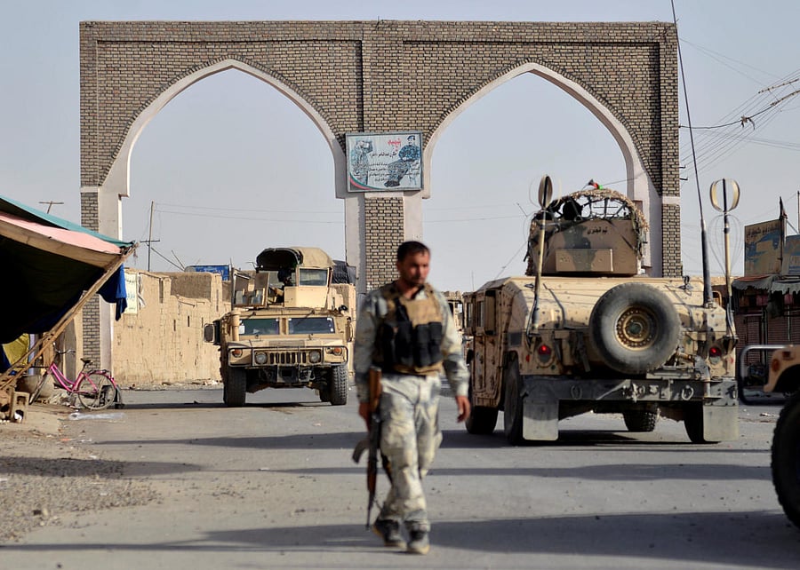 An Afghan security guard walks during a Taliban attack in Ghazni city, Afghanistan August 12, 2018. REUTERS