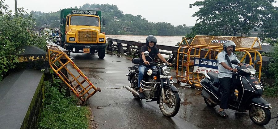 Heavy vehicles ply on Panemangaluru Old Bridge.