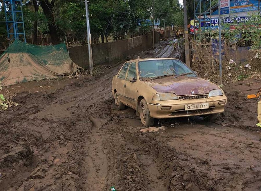 A car muddied in the flood that hit Aluva last week, left in slush on Tuesday. DH Photo