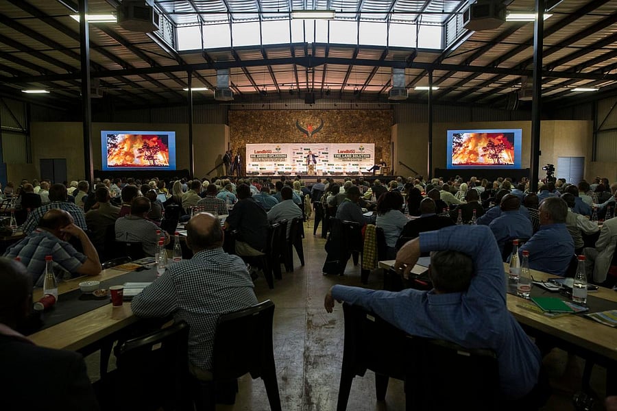 Farmers, politicians and key role players in the agriculture sector listen to South Africa Deputy President David Mabuza speak as they attend AGRISA, a South African agricultural industry association, at a conference titled "The Land Solution" on the Zwartkloof Private Game Reserve in Bela Bela on August 23, 2018. - South Africa has accused US President Donald Trump of fuelling racial tensions after he said farmers were being forced off their land and many of them killed. AFP