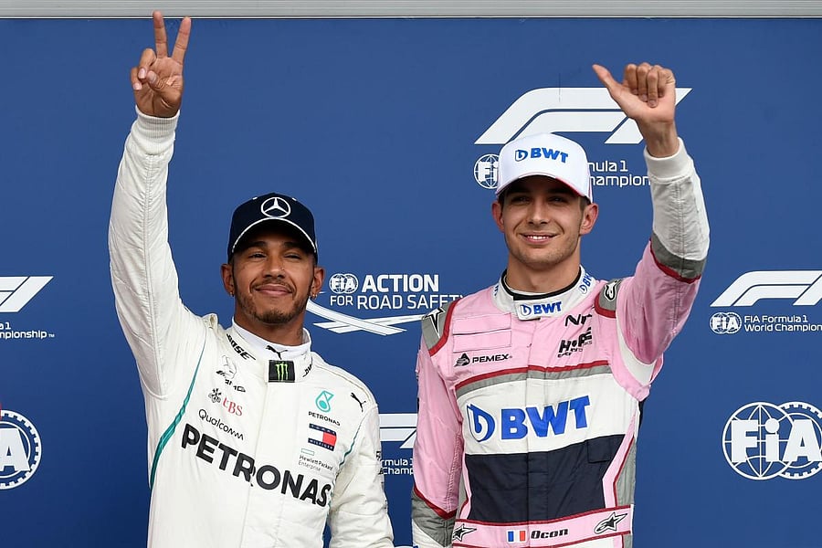 MEMORABLE: Mercedes' Lewis Hamilton (left) celebrates winning the pole position next to third placed Racing Point Force India's Esteban Ocon. AFP