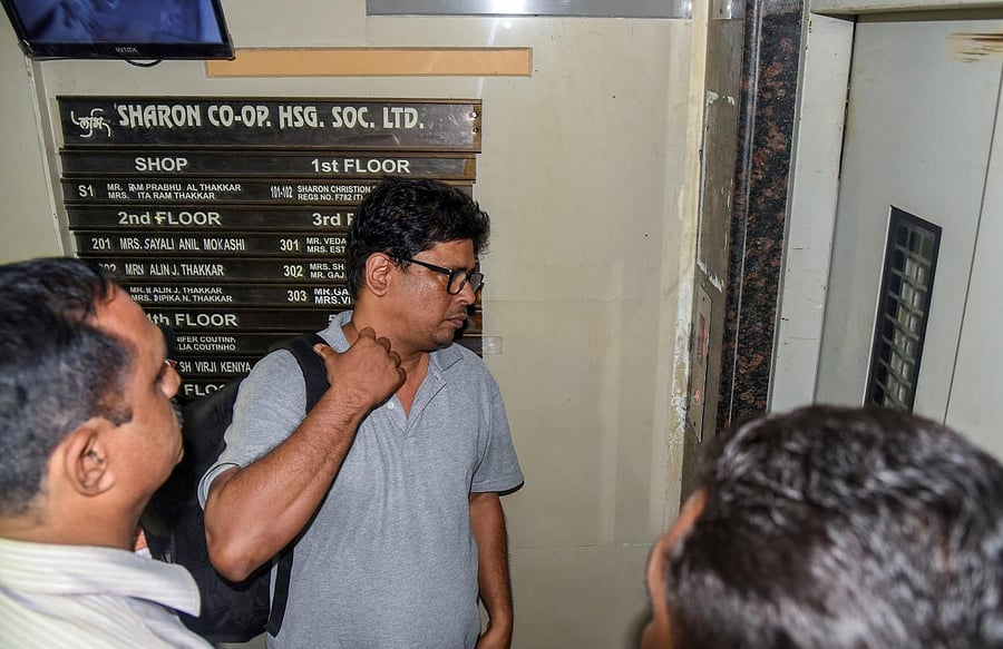 Social activist-lawyer Arun Ferreira looks on after he was brought back to his residence and placed under house arrest, in Thane on Thursday, Aug 30, 2018. Supreme Court gave relief to Ferreira and four other rights activists, who were arrested for their alleged role in Bhima-Koregaon violence. PTI
