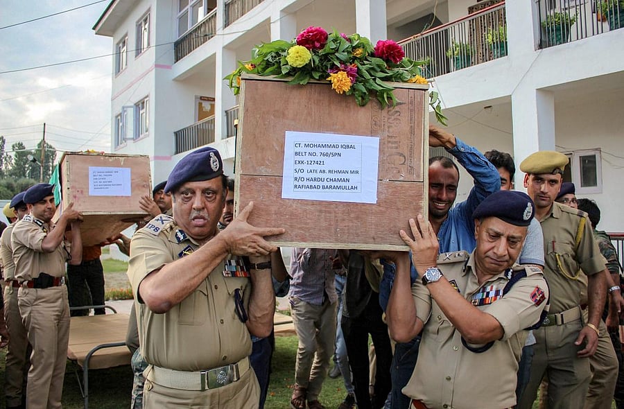 Director General of Jammu and Kashmir Police SP Vaid along with ADGP Munir Khan, IG SP Pani and others carry the bodies of four policemen who were killed in a militant attack on a police party, in Shopian district of South Kashmir on Wednesday. PTI