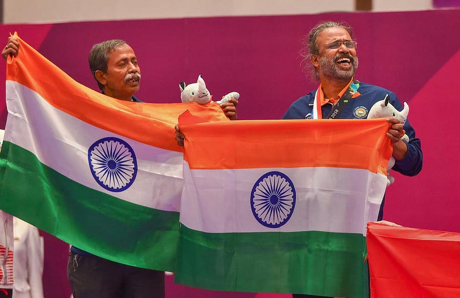 Jakarta: Gold medallist India's Pranab Bardhan and Shibhnath Sarkar pose with the Indian tricolour after winning in bridge competition at the 18th Asian Games in Jakarta on Saturday, Sept 1, 2018. (PTI Photo/Shahbaz Khan) (PTI9_1_2018_000058B)