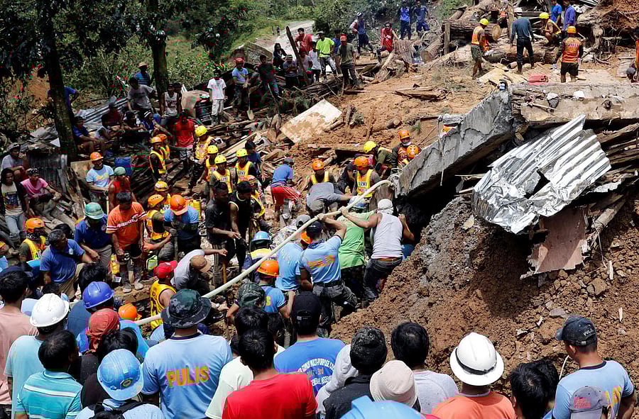 Rescuers search for people trapped in a landslide caused by Typhoon Mangkhut at a small-scale mining camp in Itogon, Benguet, in the Philippines, on September 17, 2018. Reuters