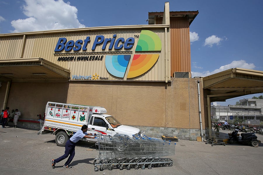 FILE PHOTO: A man pushes shopping trolleys at a Walmart India's Best Price Modern Wholesale store in Jammu on May 8, 2018. Reuters