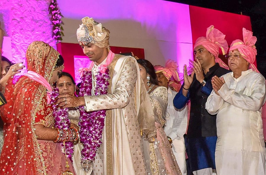 RJD chief Lalu Prasad's elder son Tej Pratap and Aishwarya Rai during their wedding ceremony at Veterinary College Ground in Patna on Saturday. PTI