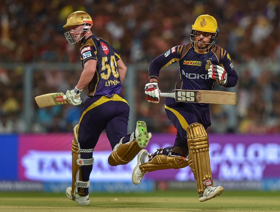 Kolkata Knight Riders (KKR) batsmen Chris Lynn and Nitish Rana cross each other to complete a run during the Indian Premier League (IPL) 2nd qualifier cricket match against Sunrisers Hyderabad (SRH), at Eden Garden, in Kolkata, on Friday.