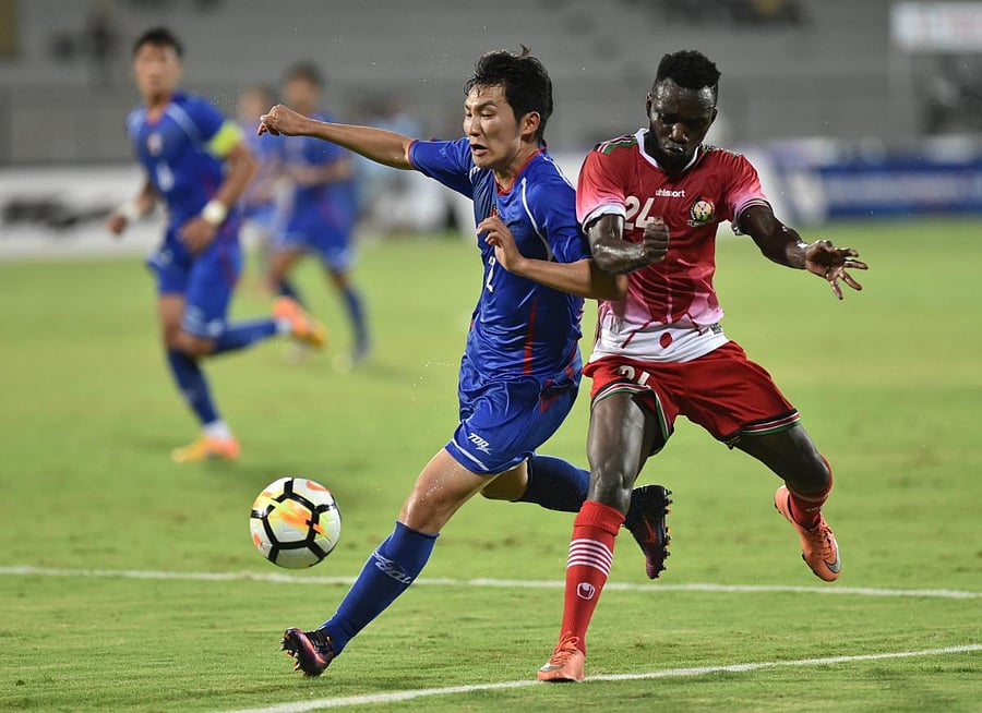 Keen tussle: Kenya's Vincent Wasambo (right) and Chinese Taipei's Chien-Ming Wang vie for the ball during their match in Mumbai on Friday. PTI