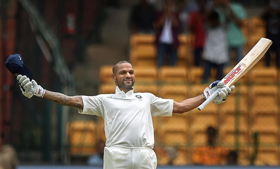 India's Shikhar Dhawan celebrates his century on the first day of the one-off cricket test match against Afghanistan, at Chinnaswamy Stadium in Bengaluru on Thursday, June 14, 2018. (PTI Photo/Shailendra Bhojak)