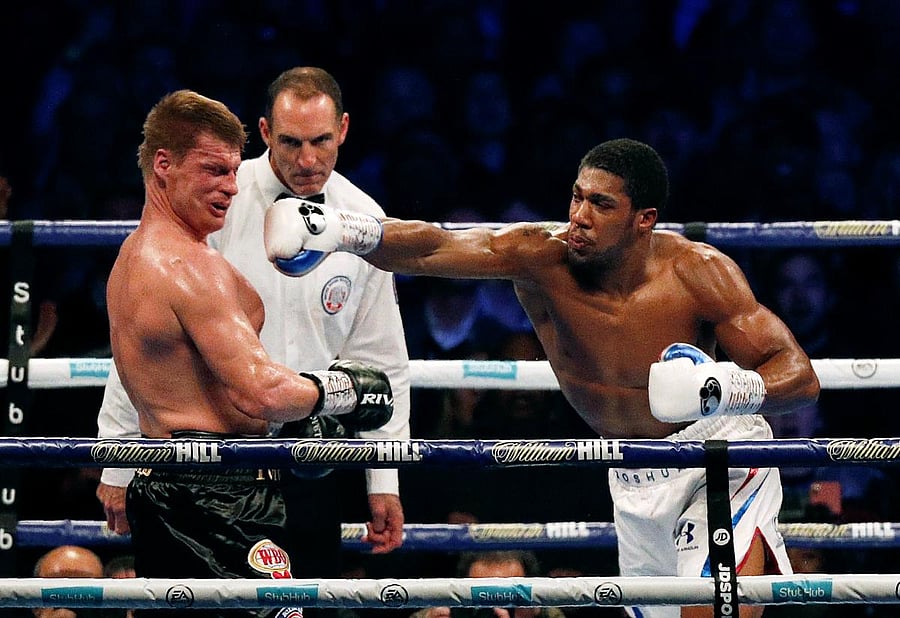 TAKE THAT Russia's Alexander Povetkin knocked down to the canvas as Britain's Anthony Joshua lands a punch during their boxing world heavyweight title fight in London on Saturday. AFP