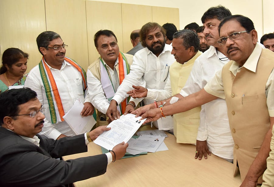 NOMINATION: Congress candidates Naseer Ahmed and M C Venugopal (second and third from left respectively) submit their nominations for bypolls to the Legislative Council, in Bengaluru on Monday. (From right) Deputy Chief Minister G Parameshwara, Minister D