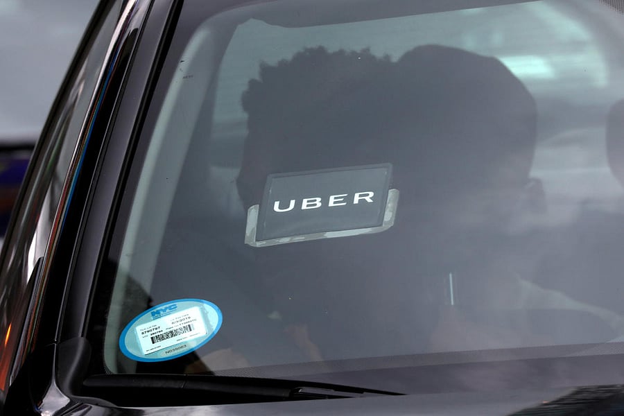 An Uber logo is seen on a car as it car drives through Times Square in New York City on July 27, 2018. Reuters