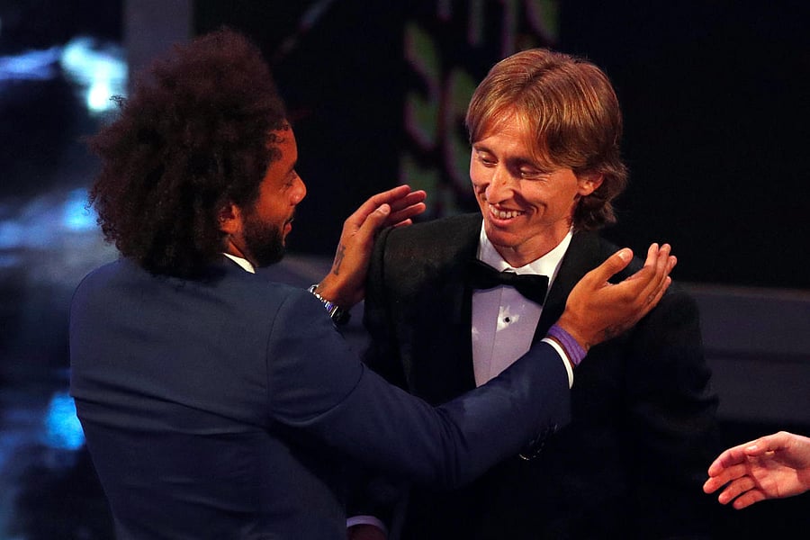 Real Madrid's Marcelo (left) congratulates his team-mate Luka Modric for winning the FIFA's best player of the year award. Reuters