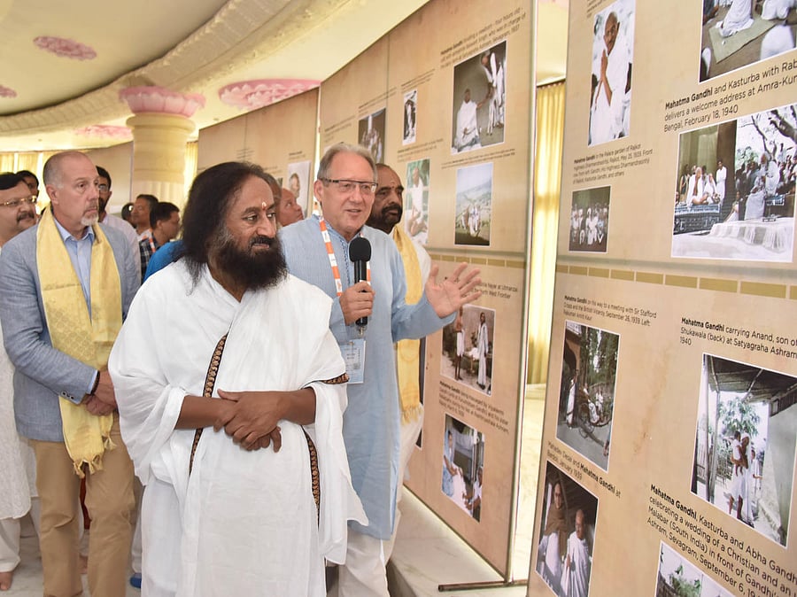 Art of Living founder Sri Ravi Shankar, Director of Strategic Studies, Police Foundation, USA, Frank Straub and Union Minister of State (MoS) Home Affairs Hansraj Ahir at the photo exhibition of Mahatma Gandhi as the part of 2nd day of CVE summit at Art o