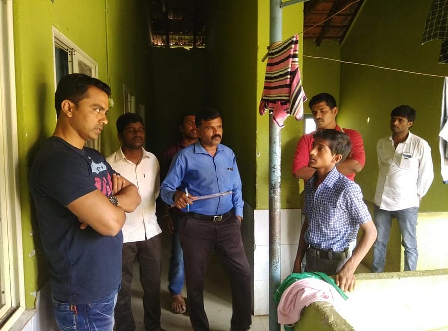 Lokayukta Inspector Sachin listens to woes of the students in the Government Boys’ Hostel in Mudigere on Thursday during a surprise visit.