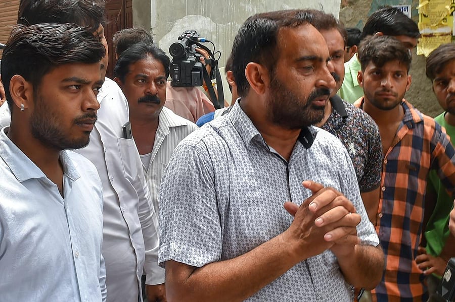 Relatives mourn after the cremation of the 11 members of a family, who were found hanging in their house in Burari, at Nigambodh Ghat in New Delhi on Monday. PTI