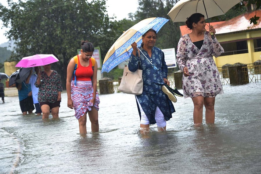 Devotees make their way through the flood water to Bhagandeshwara Temple.