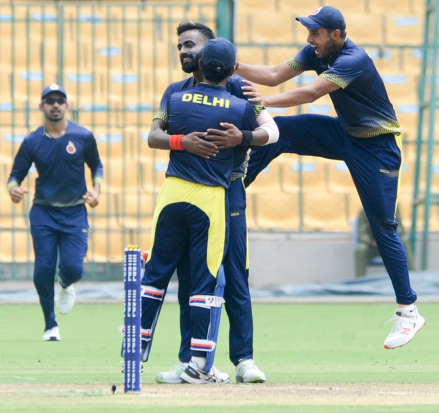 Kulwant Khejroliya is congratulated by his team-mates after taking a hat-trick.