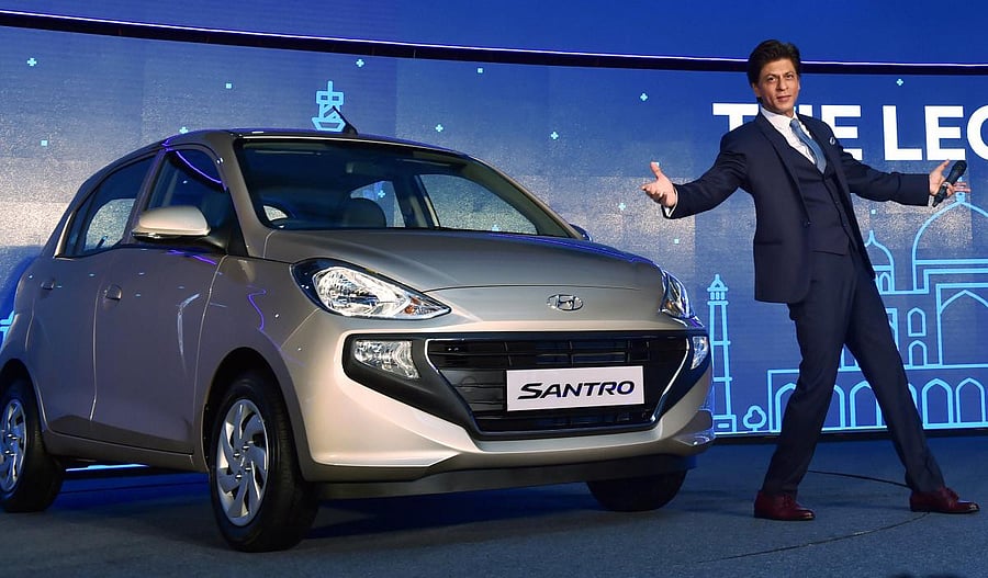 Bollywood actor & Hyundai brand ambassador Shah Rukh Khan poses for photos at the launch of the new Santro in New Delhi. PTI file photo