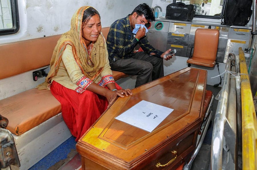 A Family member mourns near a casket containing remains of one of the Indians abducted by the Islamic State in 2014, that were found in a mass grave outside Mosul. PTI