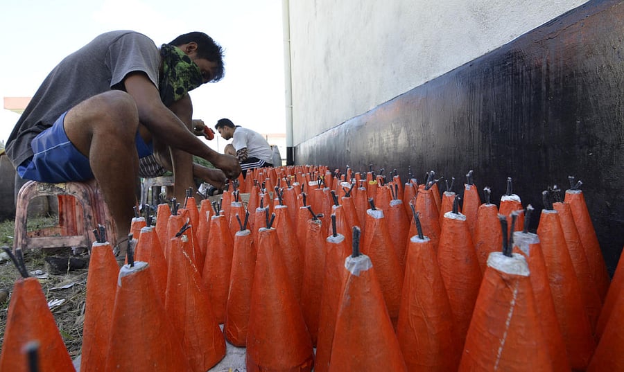 Fire cracker makers at Ganak Kuchi village in Assam's Barpeta district recently. Photo by Manash Das
